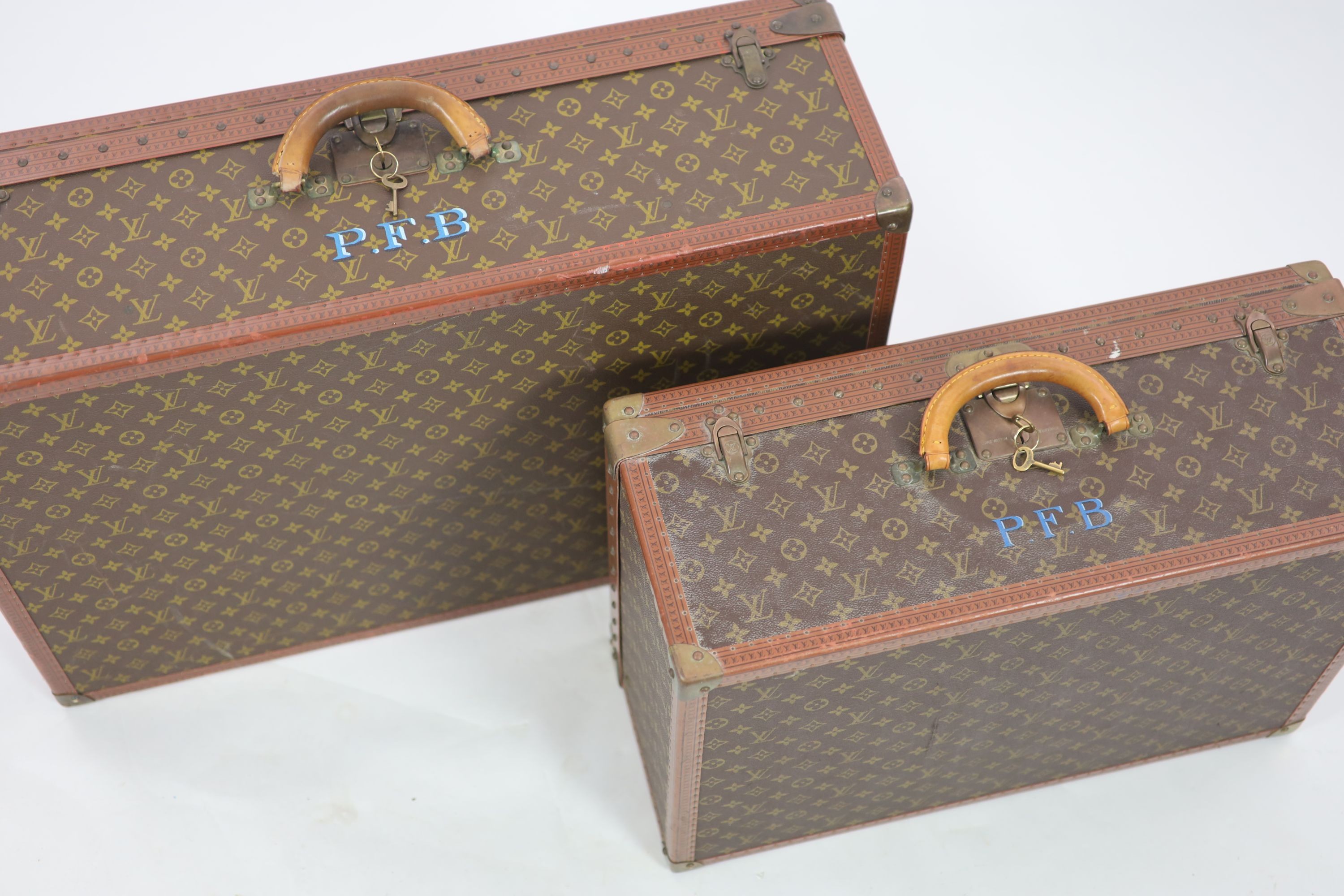 Two graduated Louis Vuitton Alzer suitcase trunks